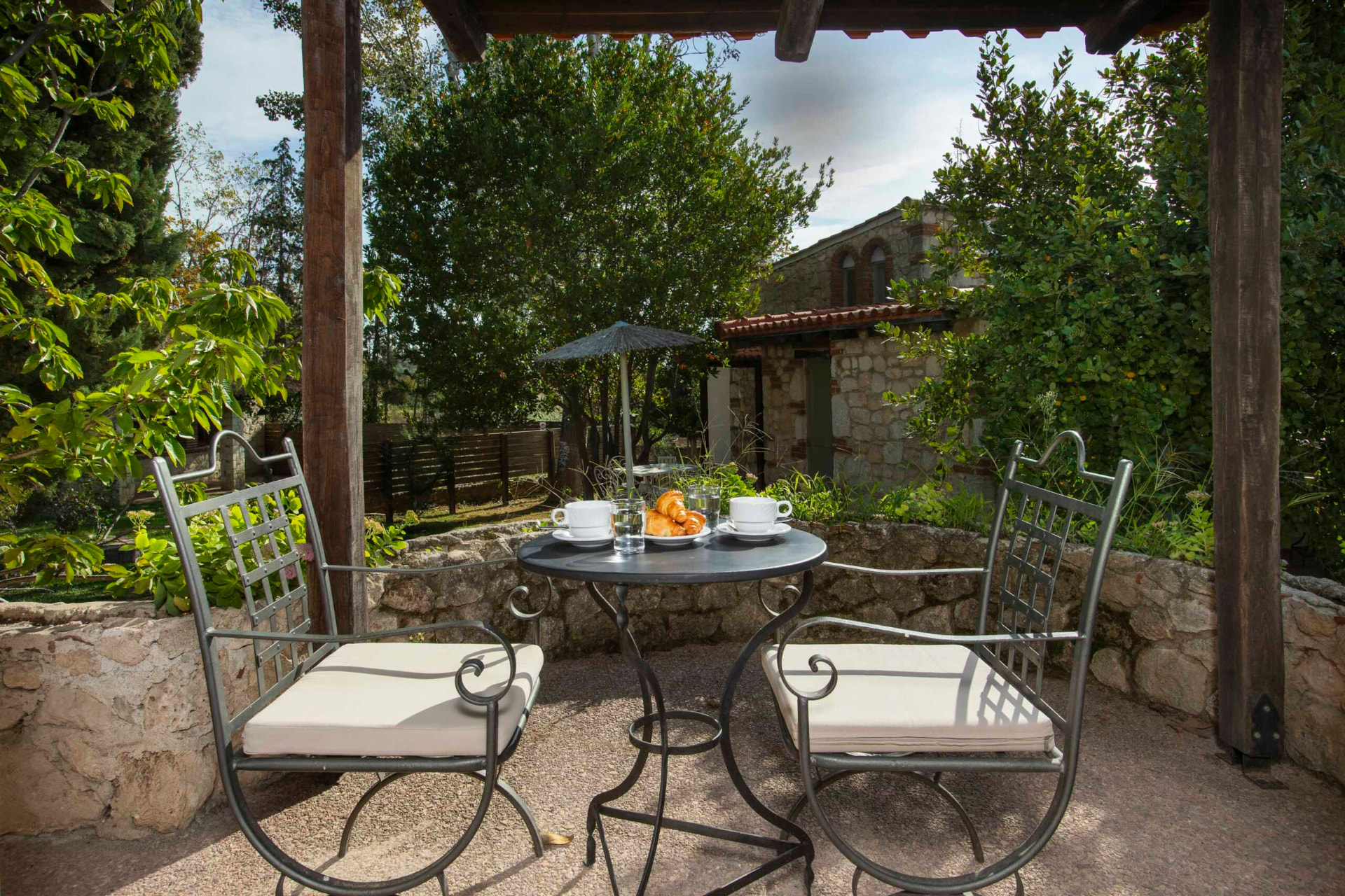 Shaded pergola terrace overlooking the gardens.