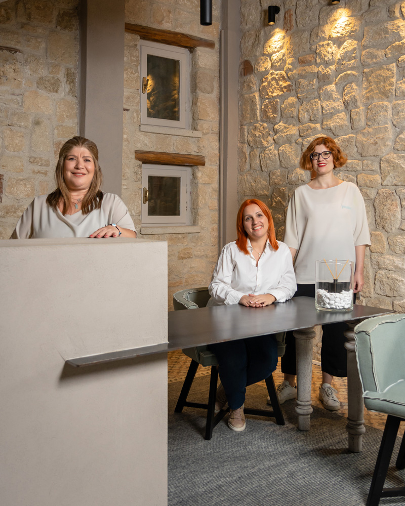 Front desk team inside the stone-built reception