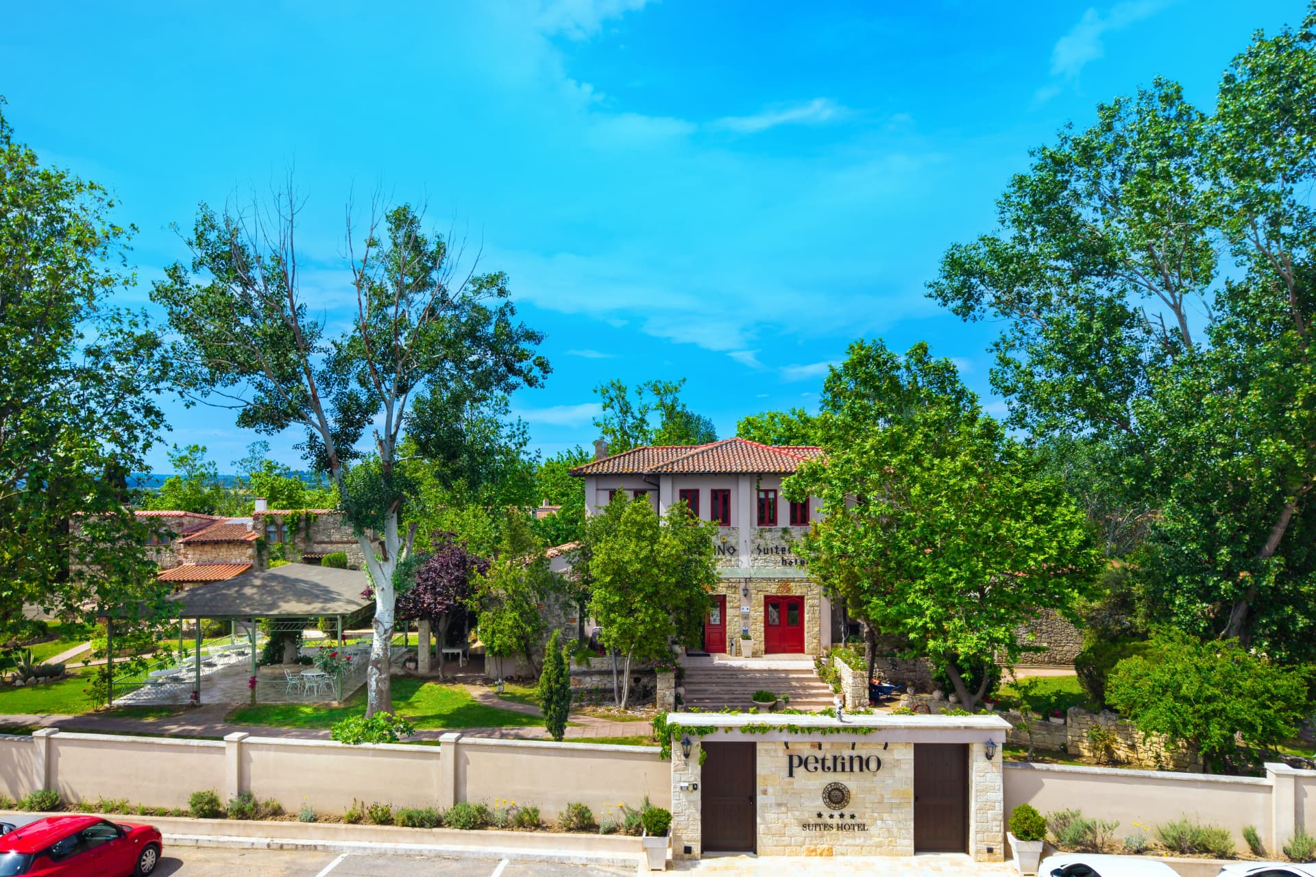 Front entrance and stone gate of Petrino Suites Hotel