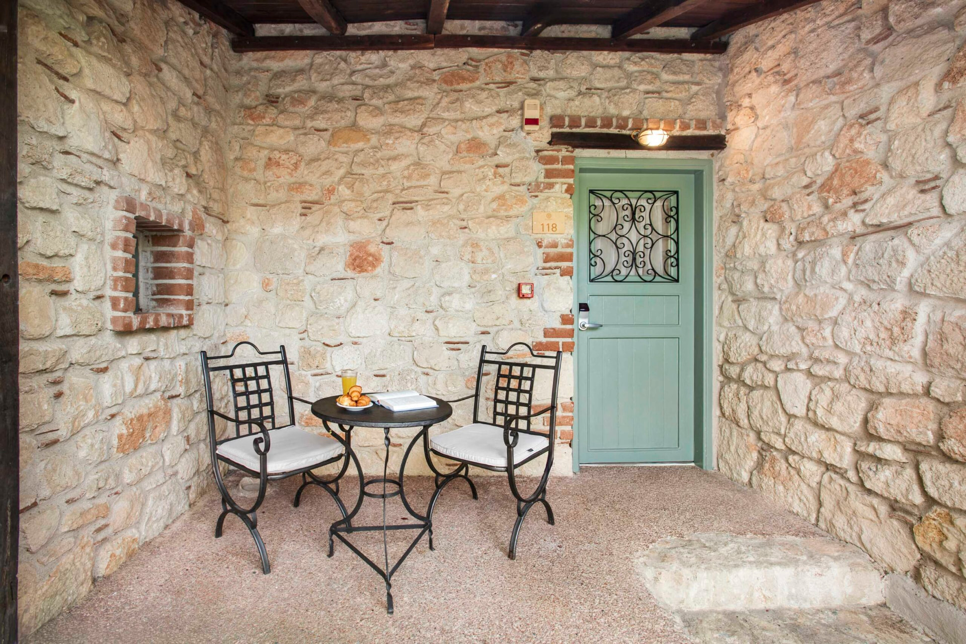 Private stone courtyard with breakfast table for two.