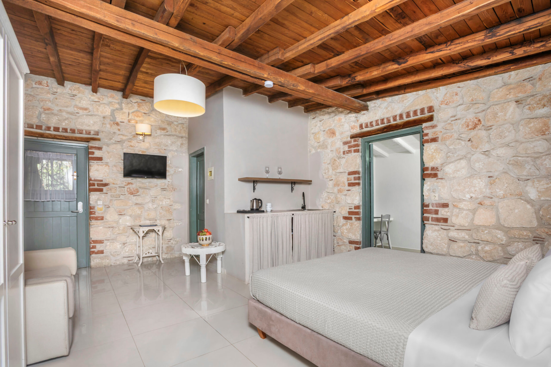 Open-plan living area with kitchenette and double bed.