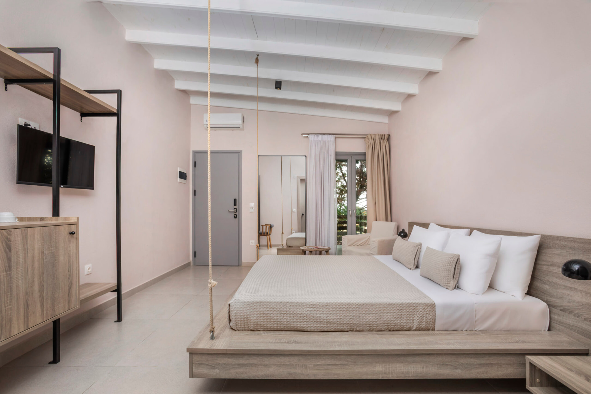 Junior Suite with king bed, seating area and balcony doors.
