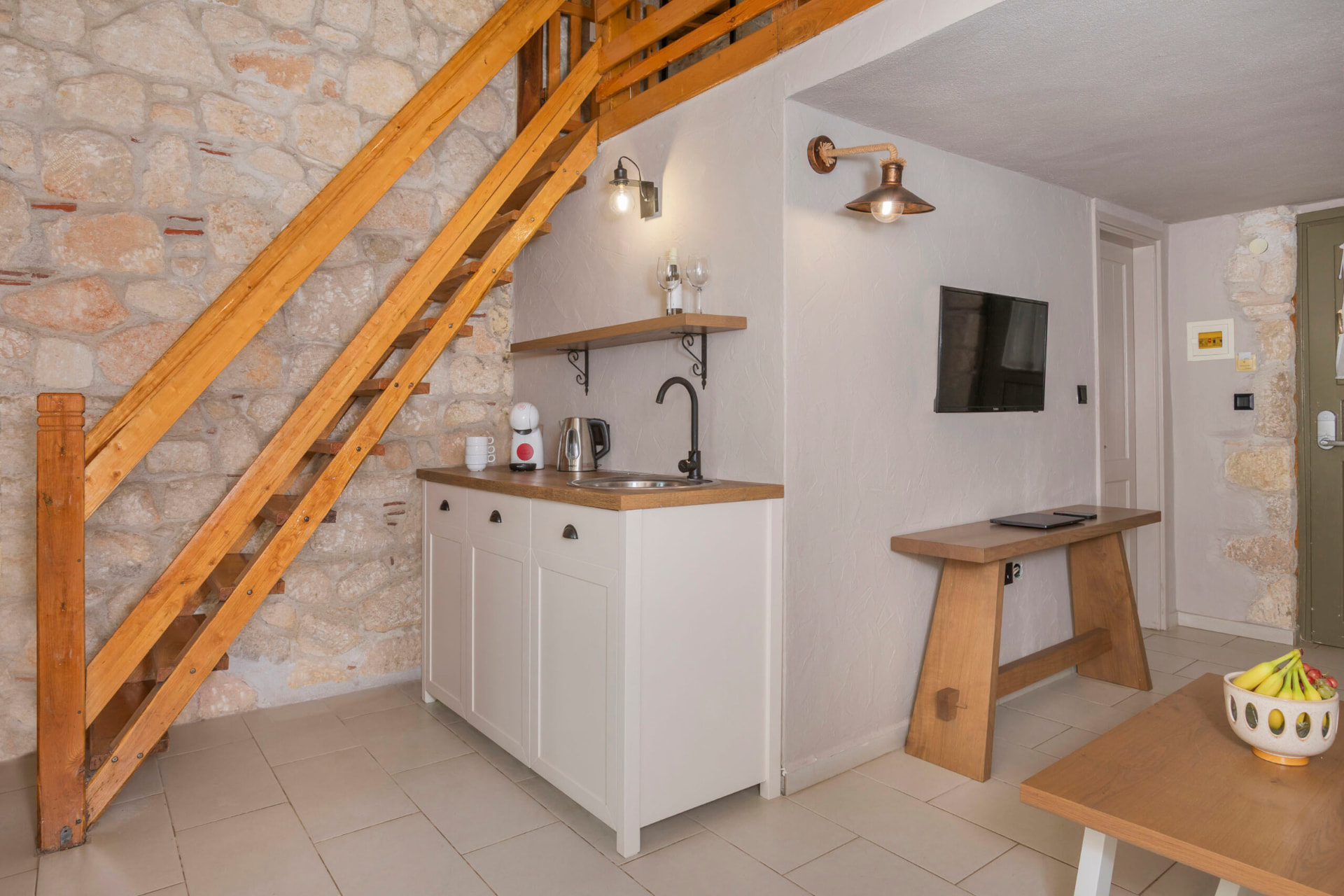 Kitchenette with wooden staircase to the loft.